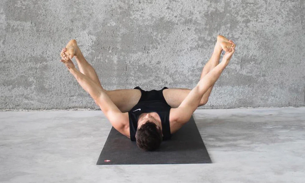 happy baby pose yoga stretch to open hip flexors and improve deep body flexibility