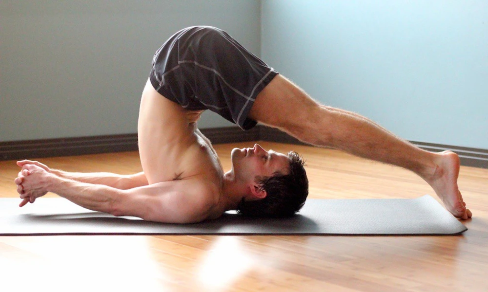 yoga plow pose halasana stretch for deep spinal flexion and inverted body control